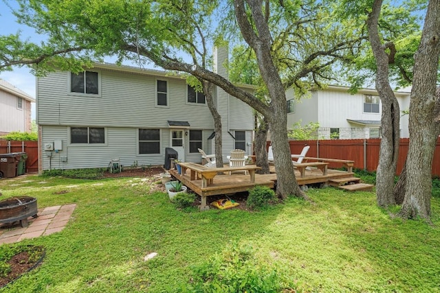 8410 Glen Canyon Dr, Round Rock, TX 78681 - rear view of house featuring a fire pit, a fenced backyard, a wooden deck, and a chimney