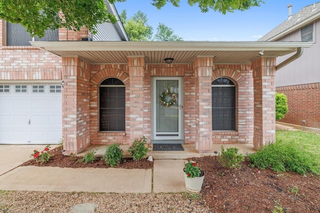 8410 Glen Canyon Dr, Round Rock, TX 78681 - entrance to property featuring a porch, brick siding, and an attached garage