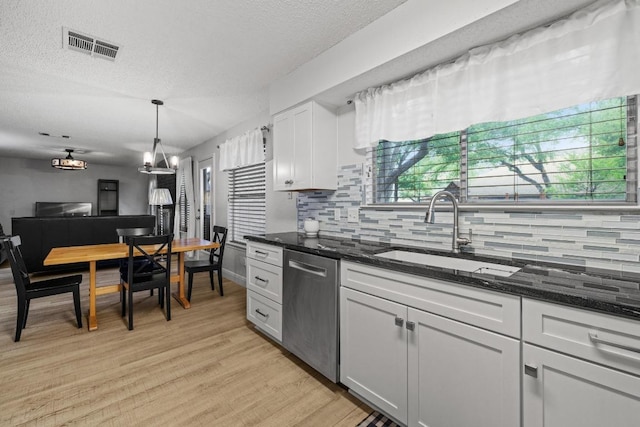 8410 Glen Canyon Dr, Round Rock, TX 78681 - kitchen with dishwasher, backsplash, light wood-style floors, and a textured ceiling