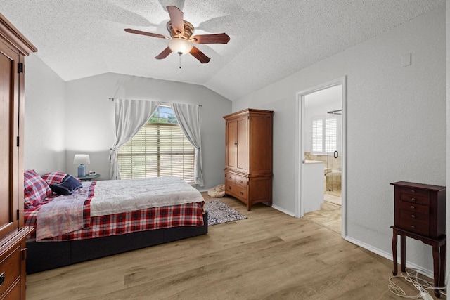 8410 Glen Canyon Dr, Round Rock, TX 78681 - bedroom with light wood-style flooring, vaulted ceiling, a textured ceiling, multiple windows, and ensuite bathroom