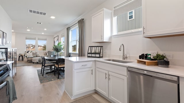 2620 Caleb Asher Loop, Round Rock, TX 78665 - kitchen with appliances with stainless steel finishes, light wood finished floors, white cabinetry, light countertops, and recessed lighting