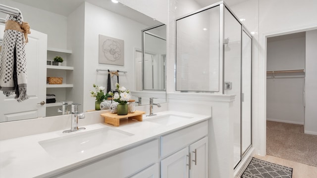 2620 Caleb Asher Loop, Round Rock, TX 78665 - full bathroom featuring a stall shower, double vanity, and a walk in closet