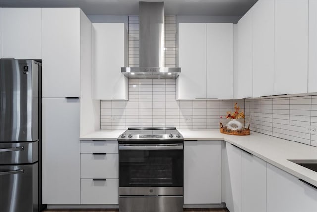 2220 Webberville Rd Unit 207, Austin, TX 78702 - kitchen with stainless steel appliances, wall chimney exhaust hood, white cabinetry, and light countertops