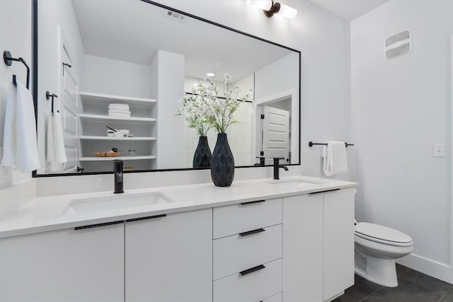 2220 Webberville Rd Unit 207, Austin, TX 78702 - full bath with double vanity, toilet, tile patterned floors, and baseboards