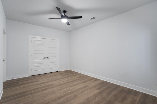 2220 Webberville Rd Unit 207, Austin, TX 78702 - unfurnished bedroom featuring wood finished floors, baseboards, and a closet