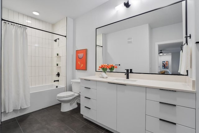 2220 Webberville Rd Unit 207, Austin, TX 78702 - bathroom featuring vanity, shower / bath combo with shower curtain, toilet, tile patterned floors, and ceiling fan
