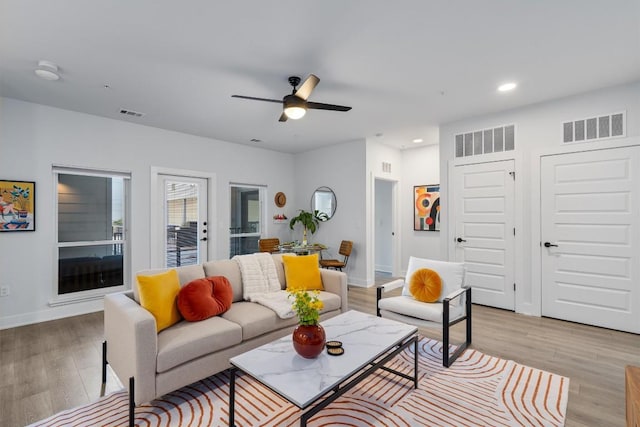 2220 Webberville Rd Unit 207, Austin, TX 78702 - living room with light wood finished floors, recessed lighting, a ceiling fan, and baseboards