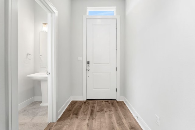 2201 Cento Walk Unit 70, Round Rock, TX 78664 - doorway featuring wood finished floors and baseboards