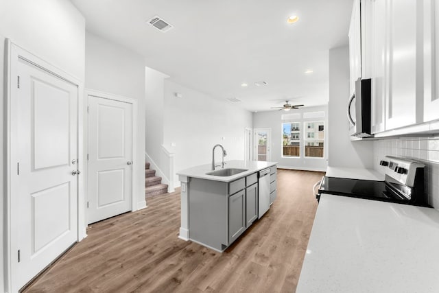 2201 Cento Walk Unit 70, Round Rock, TX 78664 - kitchen featuring a sink, gray cabinets, appliances with stainless steel finishes, recessed lighting, and light wood finished floors