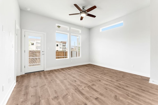 2201 Cento Walk Unit 70, Round Rock, TX 78664 - unfurnished room featuring plenty of natural light, a ceiling fan, light wood-type flooring, and baseboards