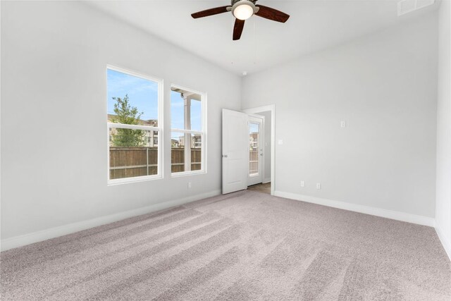 2201 Cento Walk Unit 70, Round Rock, TX 78664 - spare room with a ceiling fan, light colored carpet, plenty of natural light, and baseboards