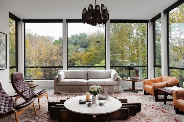 2700 Stratford Dr, Austin, TX 78746 - sunroom / solarium featuring expansive windows, a chandelier, and a wooded view