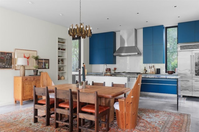 2700 Stratford Dr, Austin, TX 78746 - dining room with a chandelier, built in shelves, and concrete floors