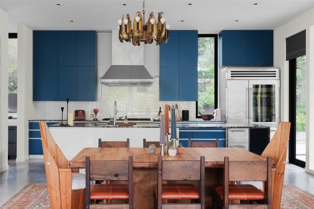 2700 Stratford Dr, Austin, TX 78746 - kitchen featuring blue cabinetry, modern cabinets, a chandelier, and backsplash
