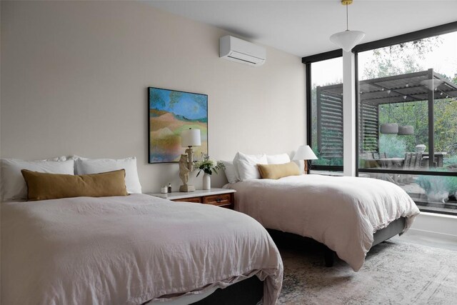 2700 Stratford Dr, Austin, TX 78746 - bedroom with a wall mounted air conditioner and expansive windows