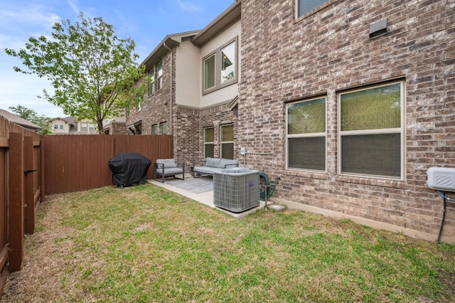 view of yard featuring a patio, central air condition unit, a fenced backyard, and outdoor lounge area