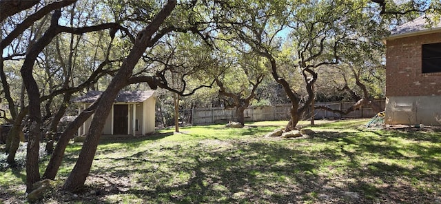 view of yard featuring an outbuilding and a storage shed