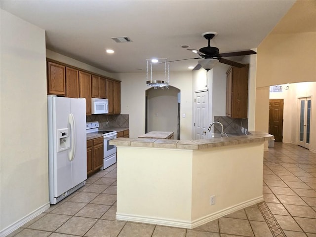 kitchen featuring white appliances, light tile patterned floors, tasteful backsplash, and recessed lighting