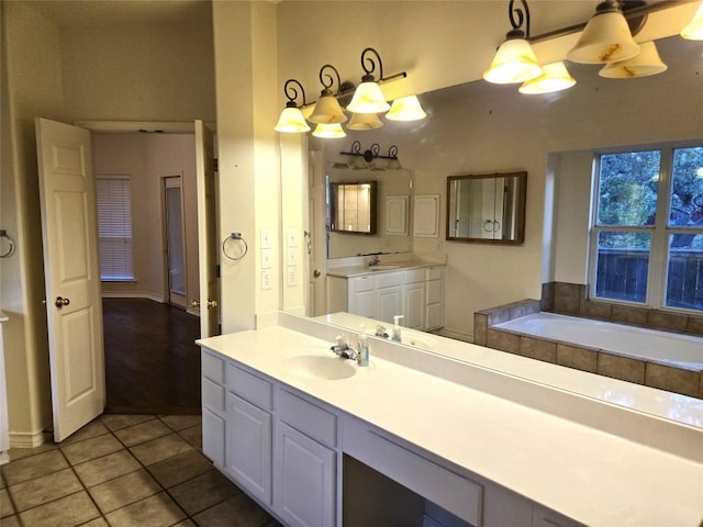 full bath featuring tile patterned floors, a tub, and vanity