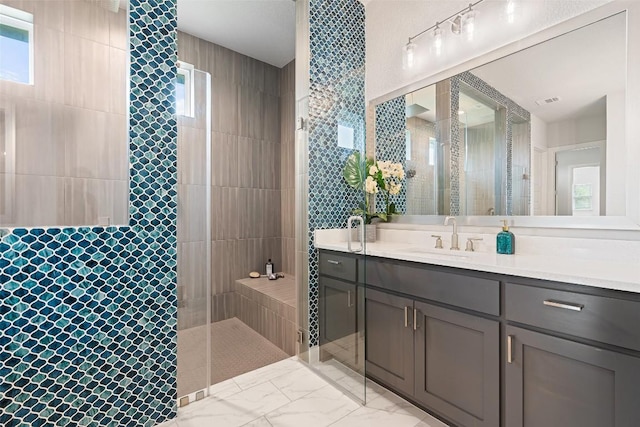 2421 High Lonesome, Leander, TX 78641 - bathroom with visible vents, tile walls, a walk in shower, vanity, and marble finish floor