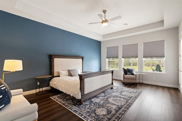 2421 High Lonesome, Leander, TX 78641 - bedroom featuring a raised ceiling, baseboards, wood finished floors, and visible vents