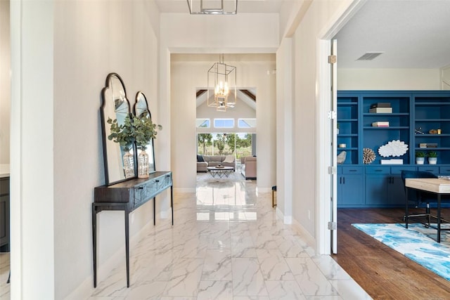 2421 High Lonesome, Leander, TX 78641 - entrance foyer featuring an inviting chandelier, baseboards, visible vents, and marble finish floor