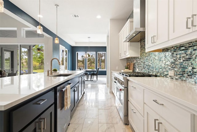 2421 High Lonesome, Leander, TX 78641 - kitchen featuring visible vents, decorative backsplash, wall chimney range hood, a sink, and stainless steel appliances