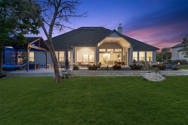 2421 High Lonesome, Leander, TX 78641 - back of property featuring roof with shingles, a sunroom, a chimney, and a yard
