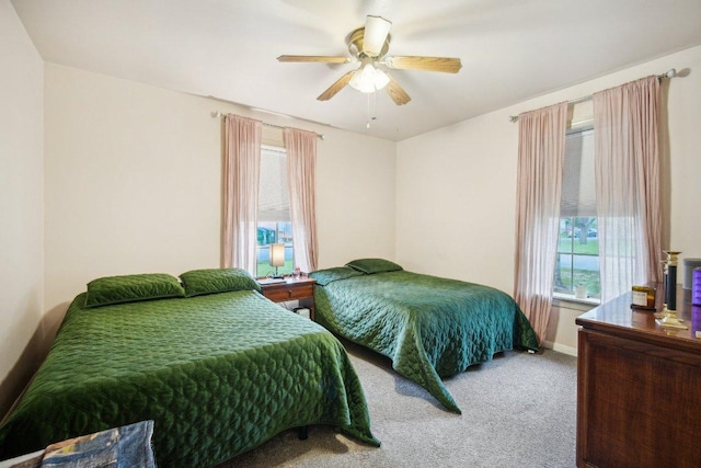 carpeted bedroom with baseboards and ceiling fan
