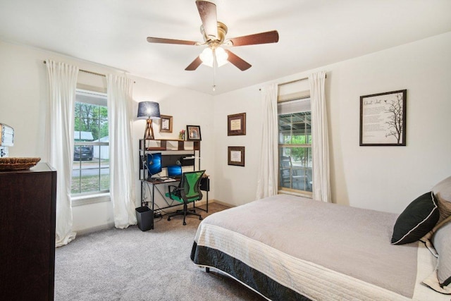 carpeted bedroom featuring a ceiling fan and baseboards