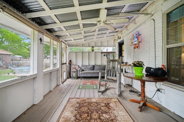 sunroom / solarium with a ceiling fan