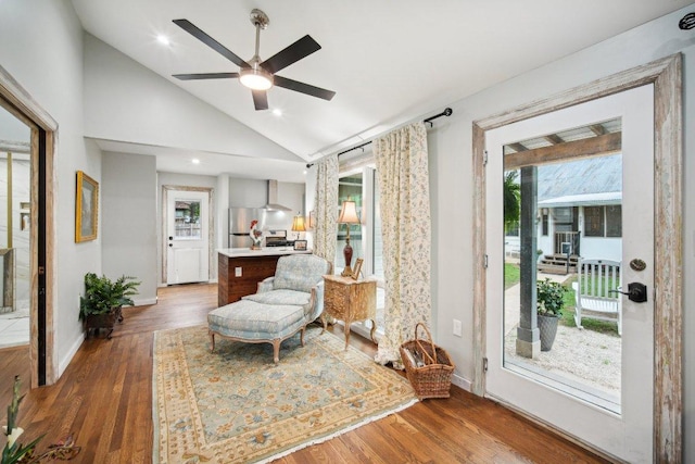 sitting room featuring baseboards, high vaulted ceiling, wood finished floors, and ceiling fan