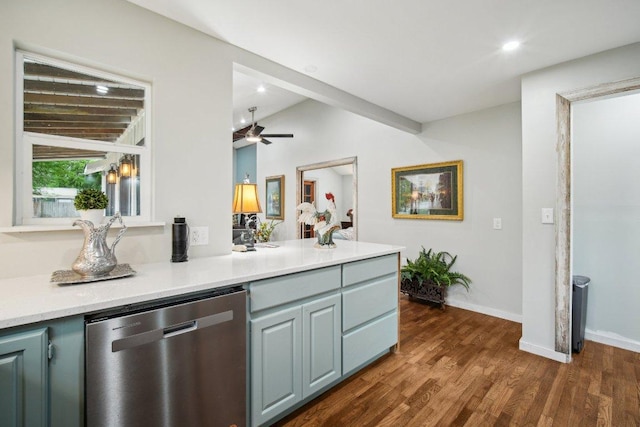 kitchen featuring light countertops, dark wood-type flooring, baseboards, stainless steel dishwasher, and a ceiling fan