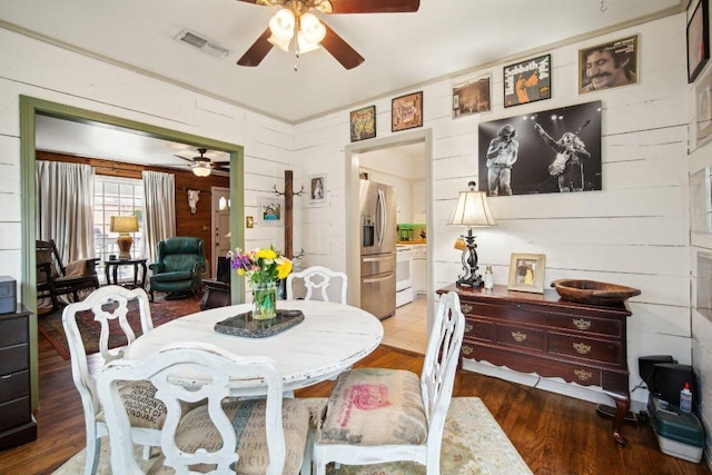 dining room featuring a ceiling fan, wood finished floors, and visible vents