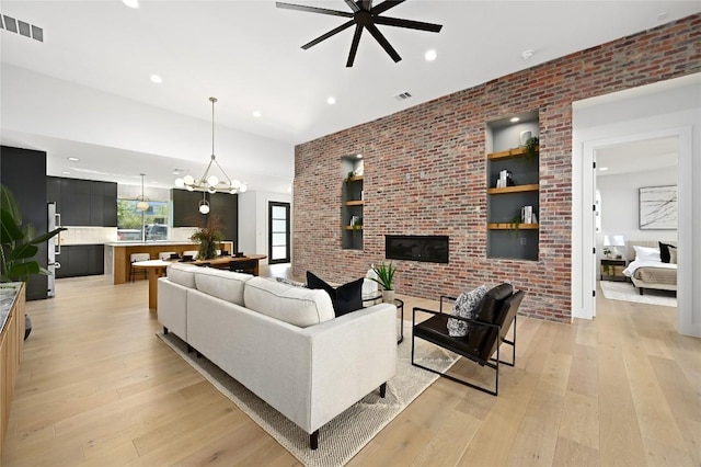 3004 Ray Wood Dr, Austin, TX 78704 - living room with a ceiling fan, light wood finished floors, recessed lighting, a chandelier, and brick wall