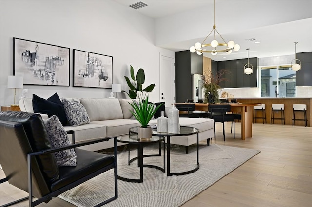 3004 Ray Wood Dr, Austin, TX 78704 - living area featuring wood finished floors, a chandelier, and recessed lighting