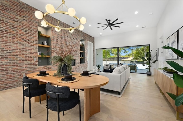 3004 Ray Wood Dr, Austin, TX 78704 - dining space with brick wall, a towering ceiling, recessed lighting, and light wood-type flooring
