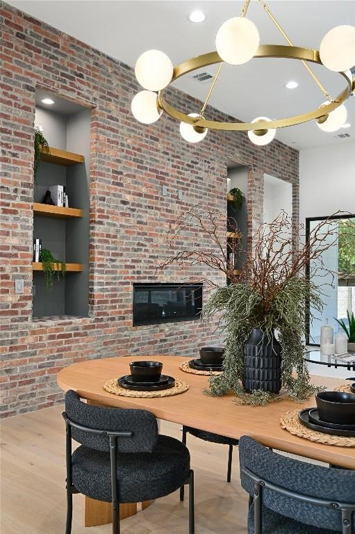 3004 Ray Wood Dr, Austin, TX 78704 - dining area with brick wall, a glass covered fireplace, and wood finished floors