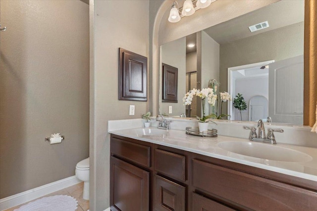 2608 Lightfoot Trl, Austin, TX 78745 - bathroom featuring toilet, tile patterned floors, double vanity, and baseboards