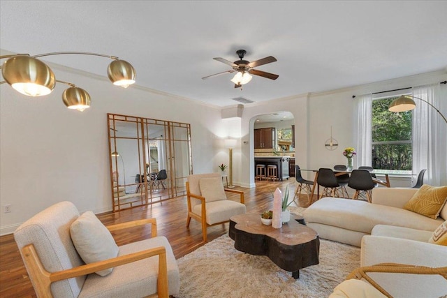 2608 Lightfoot Trl, Austin, TX 78745 - living room with arched walkways, ceiling fan, and wood finished floors