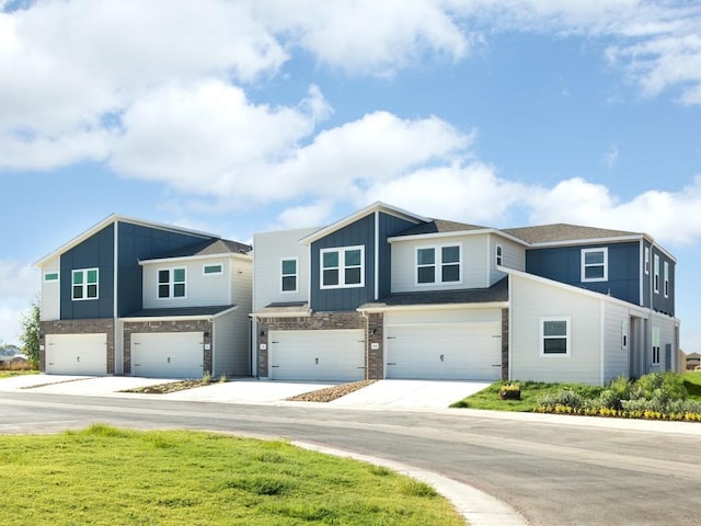 1850 Settlers Glen Dr Unit 601, Round Rock, TX 78665 - view of front of property with driveway, stone siding, an attached garage, and board and batten siding
