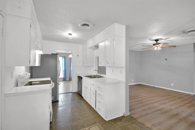 kitchen featuring white cabinetry, light countertops, stainless steel appliances, a sink, and a ceiling fan