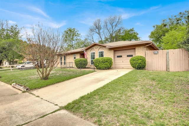 ranch-style house with driveway, a garage, fence, and a front lawn