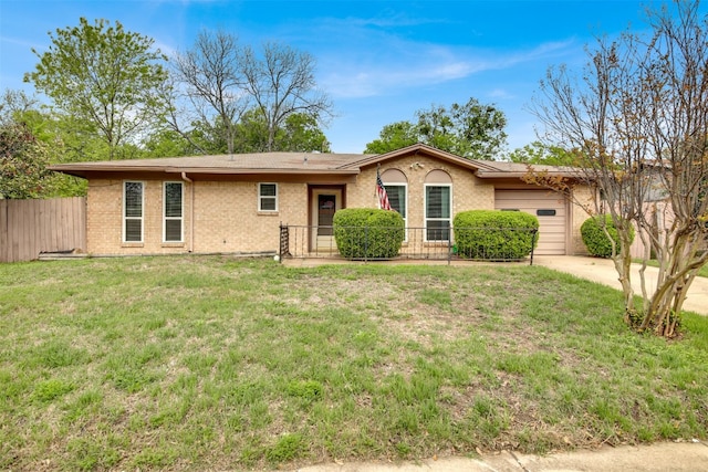 single story home featuring fence, an attached garage, driveway, a front lawn, and brick siding