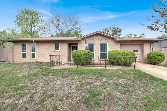 ranch-style house with fence, an attached garage, driveway, a front yard, and brick siding