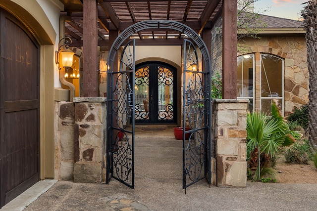 15086 Barrie Dr, Austin, TX 78734 - property entrance featuring a gate, stone siding, and a pergola