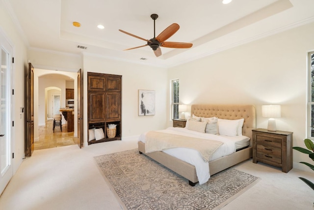 15086 Barrie Dr, Austin, TX 78734 - bedroom featuring a tray ceiling, light carpet, arched walkways, recessed lighting, and crown molding