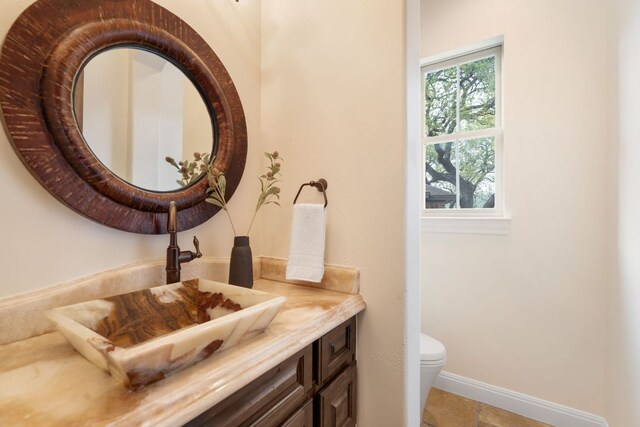 15086 Barrie Dr, Austin, TX 78734 - bathroom with toilet, vanity, and baseboards