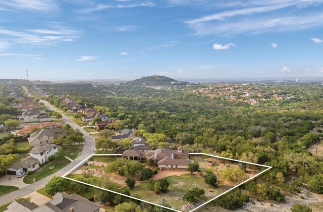 15086 Barrie Dr, Austin, TX 78734 - aerial perspective of suburban area featuring property parcel outlined and a heavily wooded area