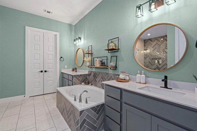 1213 Silver Dollar Trl, Georgetown, TX 78628 - full bathroom with two vanities, a bath, and tile patterned floors
